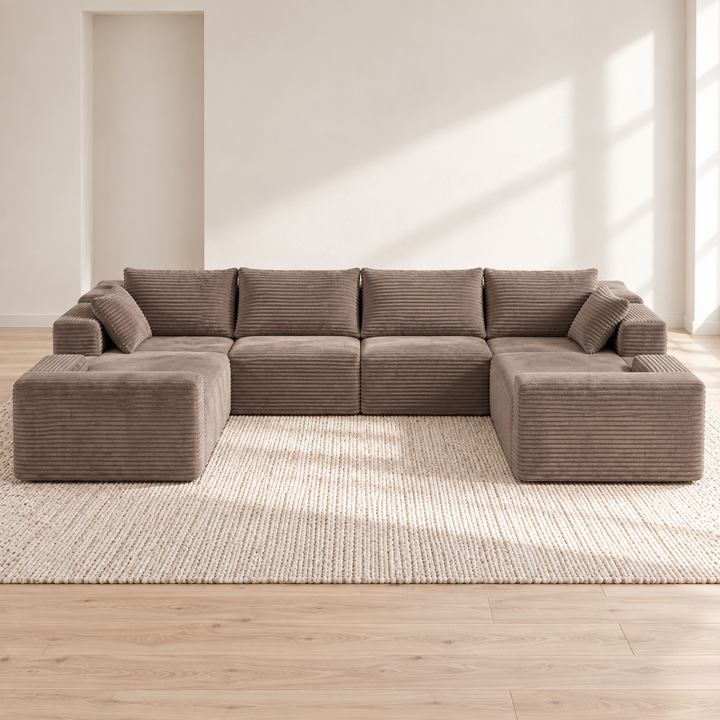 Oversized taupe corduroy U-sectional in a bright Nordic interior